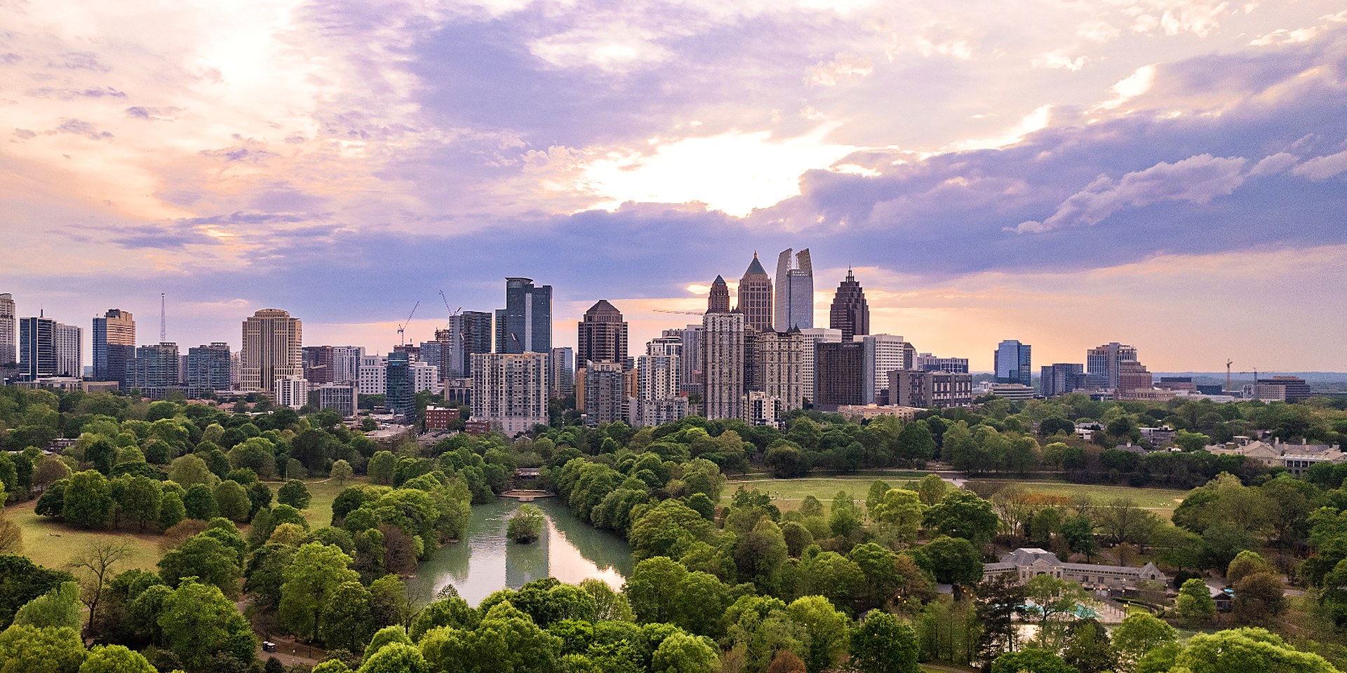 Atlanta skyline rising above Piedmont Park at sunset